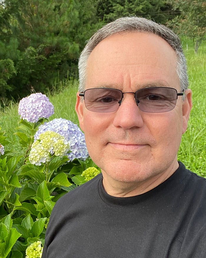 pat outside near hydrangea flowers