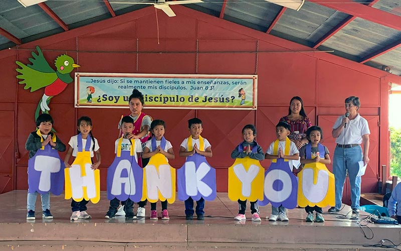 children holding THANK YOU signs