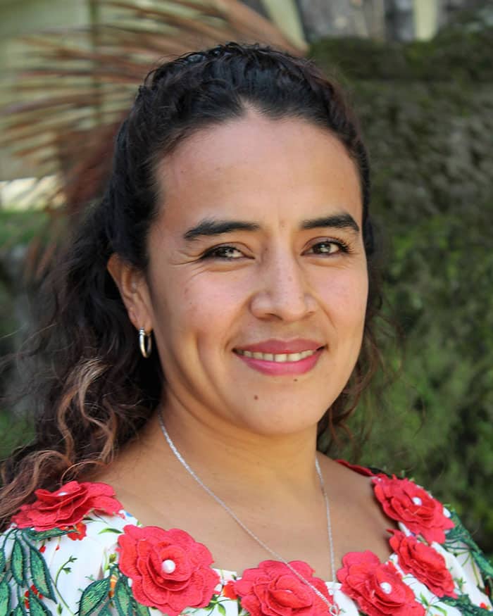 woman smiling red flowers on her dress neckline